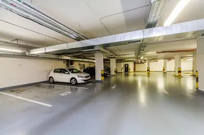 a parking garage with a car parked in it at REZIDENCE ŠVEHLOVA in Prague