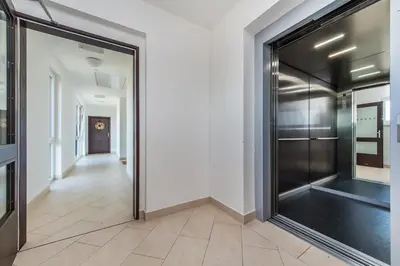 a hallway with a large glass door in a building at REZIDENCE ŠVEHLOVA in Prague