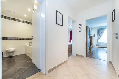 a white bathroom with a toilet and a sink at REZIDENCE ŠVEHLOVA in Prague