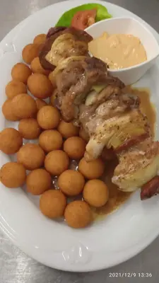a plate of food with chicken and potatoes and sauce at Malá Svatá Hora - penzion & restaurace in Mníšek pod Brdy