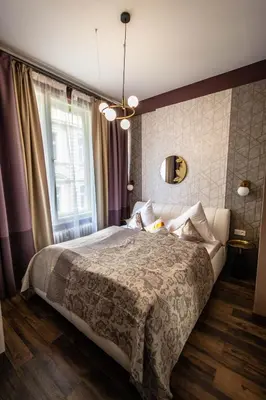 a bedroom with a large bed and a window at Colorful Day in Prague Design Apartments in Prague