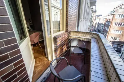 a balcony with a bench and a window at Colorful Day in Prague Design Apartments in Prague