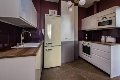 a kitchen with a refrigerator and a sink at Colorful Day in Prague Design Apartments in Prague