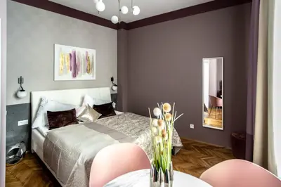 a bedroom with a bed and a table with chairs at Colorful Day in Prague Design Apartments in Prague