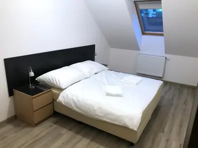 a bedroom with a bed with two towels on it at Valentine's National Museum Apartments in Prague