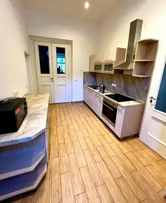 a kitchen with a wooden floor and a counter top at Valentine's National Museum Apartments in Prague