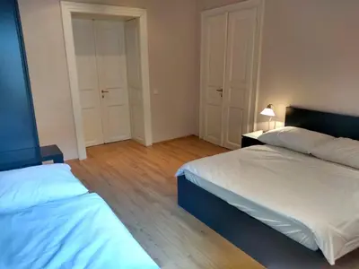 a bedroom with two beds and a lamp in it at Valentine's National Museum Apartments in Prague