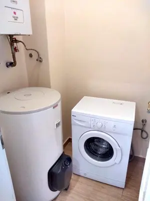 a laundry room with a washing machine and a washer at Valentine's National Museum Apartments in Prague