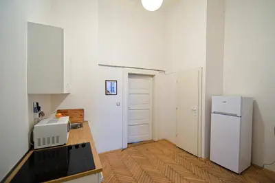 a kitchen with a white refrigerator and a counter at Dittrichova Apartment in Prague