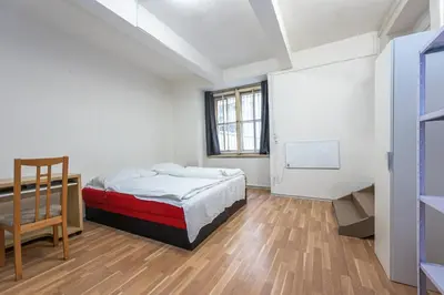 a bedroom with a bed and a chair in it at Dittrichova Apartment in Prague
