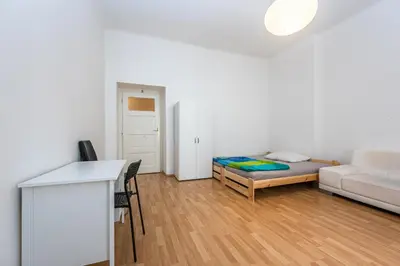 a living room with a couch and a bed at Dittrichova Apartment in Prague