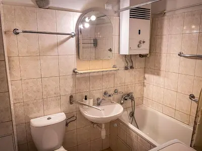 a bathroom with a toilet and a sink and a tub at Dittrichova Apartment in Prague