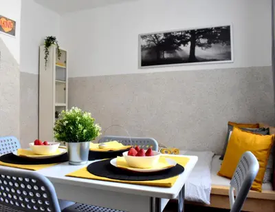 a dining room table with two bowls of fruit on it at Romantic Bijou Apartment near Old Town! in Prague