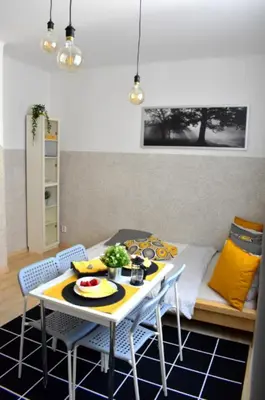 a dining room table with two chairs and a table with food on it at Romantic Bijou Apartment near Old Town! in Prague