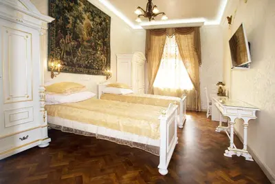 a bedroom with a bed and a painting on the wall at Art Apartments Celakovskeho Sady in Prague