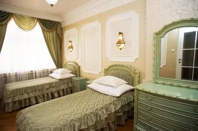 a bedroom with two beds and a dresser and a mirror at Art Apartments Celakovskeho Sady in Prague