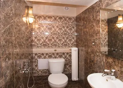 a bathroom with a toilet and a sink at Art Apartments Celakovskeho Sady in Prague