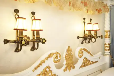a bedroom with two lights on the wall at Art Apartments Celakovskeho Sady in Prague