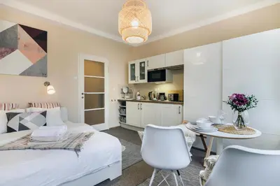 a bedroom with a bed and a table and chairs at Old Town Studio Apartment in Prague