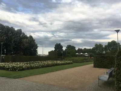 a bench sitting in a park with white flowers at Old Town Studio Apartment in Prague