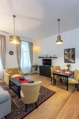 a living room with a couch and a table at A Prague Apartments - Lesser Town in Prague