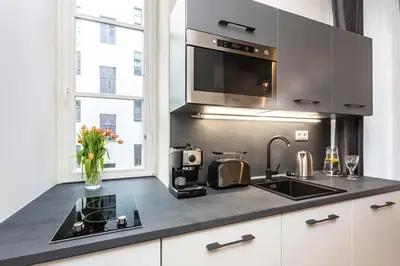 a kitchen with a sink and a microwave at A Prague Apartments - Lesser Town in Prague