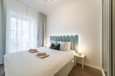 a bedroom with a large bed with two towels on it at A Prague Apartments - Lesser Town in Prague