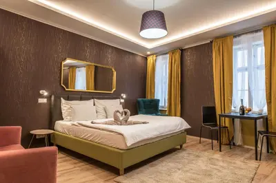 a hotel room with a bed and a chair at Prague Locals Monastery Apartments in Prague