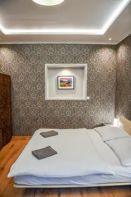 a bedroom with a bed with a picture on the wall at Prague Locals Monastery Apartments in Prague