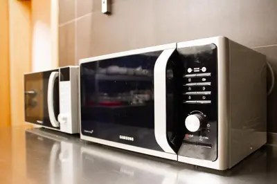 two microwaves sitting on top of a counter at Hostel Mandarinka in Prague