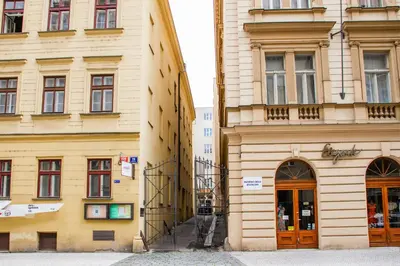 a tall yellow building next to a building at Hostel Mandarinka in Prague
