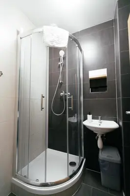 a bathroom with a shower and a sink at Hostel Mandarinka in Prague