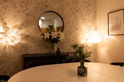 a dining room with a table and a mirror at Luxury apartment in prime location in Prague
