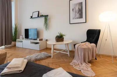 a living room with a table and a chair at Luxury apartment in prime location in Prague