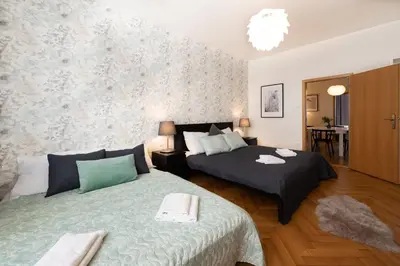 a bedroom with two beds and a table at Luxury apartment in prime location in Prague