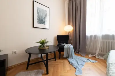 a living room with a table and a chair at Luxury apartment in prime location in Prague