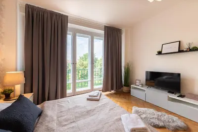 a living room with a large window and a television at Luxury apartment in prime location in Prague