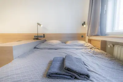 a bed with two towels sitting on top of it at Business Studio Andel, 10 min to Centre, NETFLIX, Paid Parking in Prague