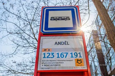 a sign for a bus stop with a bus at Business Studio Andel, 10 min to Centre, NETFLIX, Paid Parking in Prague