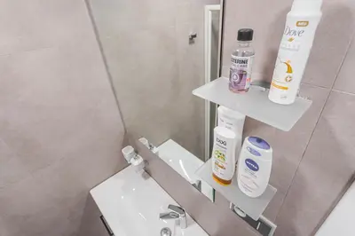 a bathroom with a sink and a mirror at Business Studio Andel, 10 min to Centre, NETFLIX, Paid Parking in Prague