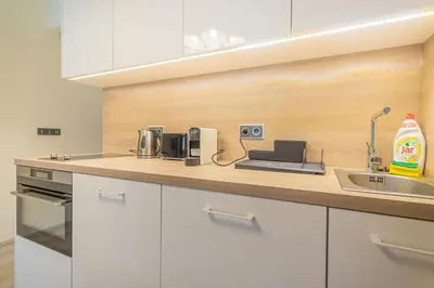 a kitchen with white cabinets and a sink at Business Studio Andel, 10 min to Centre, NETFLIX, Paid Parking in Prague