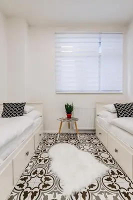 a living room with two beds and a rug at Design Pension Twenty 20 in Poděbrady