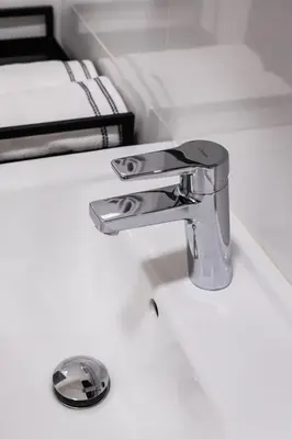 a bathroom sink with a chrome bathroom faucet at Design Pension Twenty 20 in Poděbrady