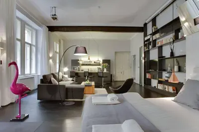 a living room with a large bed and a pink flamingo at BRIGHT Prague Havelská in Prague