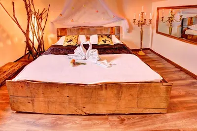a bedroom with a bed made out of a log at Štiřínská stodola u Prahy in Kamenice