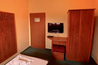 a room with a desk and a tv and a cabinet at Štiřínská stodola u Prahy in Kamenice