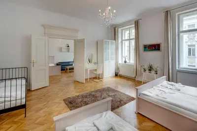 a large room with a bed and a room with a bed sqor at Kaprova - Old Town Apartments in Prague