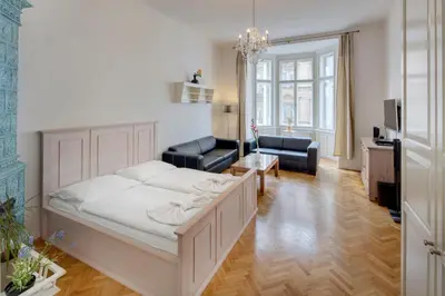 a bedroom with a bed and a couch and a living room at Kaprova - Old Town Apartments in Prague