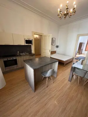 a kitchen with a table and chairs in a room at Kaprova - Old Town Apartments in Prague