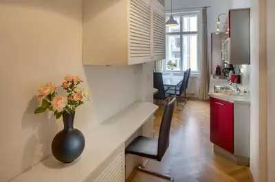 a vase with flowers sitting on a counter in a kitchen at Kaprova - Old Town Apartments in Prague